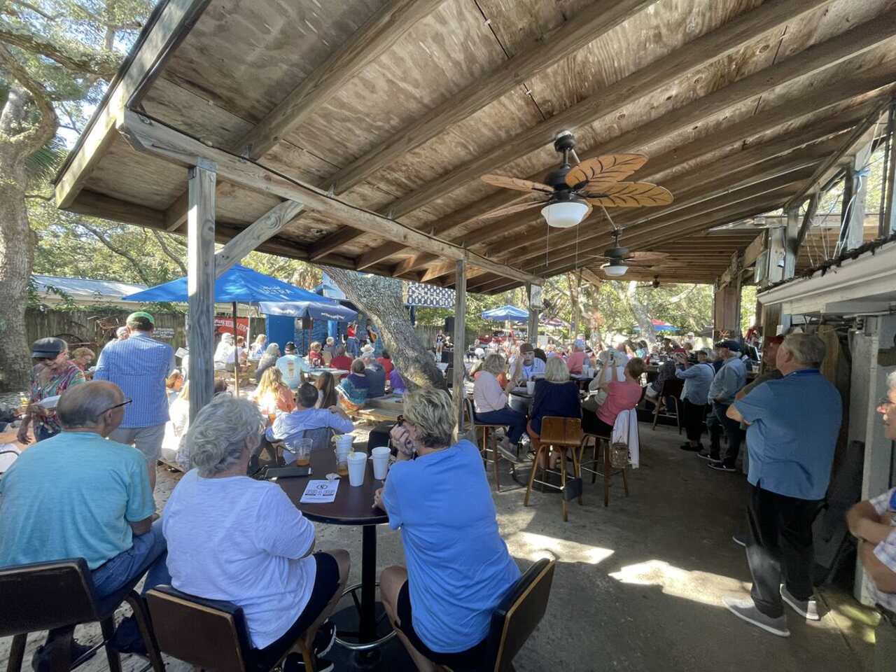 Packed courtyard of guests enjoying live music at The Point Restaurant in Perdido, FL