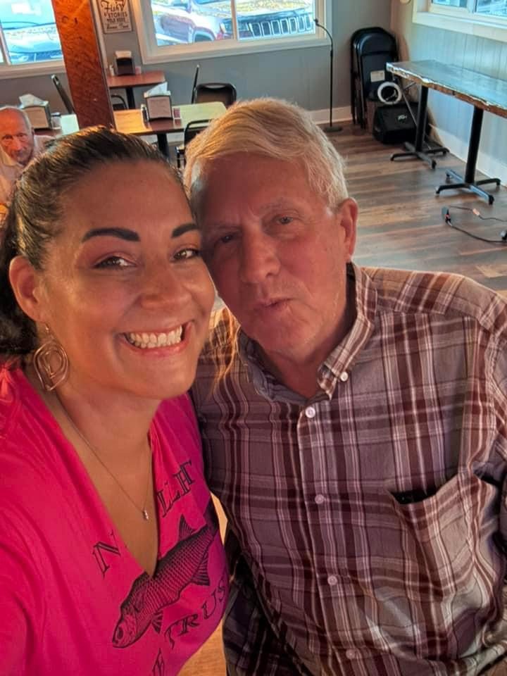 Longtime regulars smiling together in the dining room at The Point Restaurant Perdido