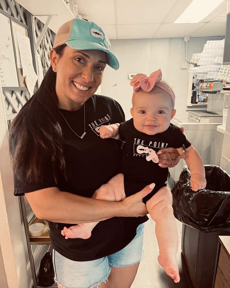 Staff member and her baby in matching The Point Restaurant shirts in Perdido, FL